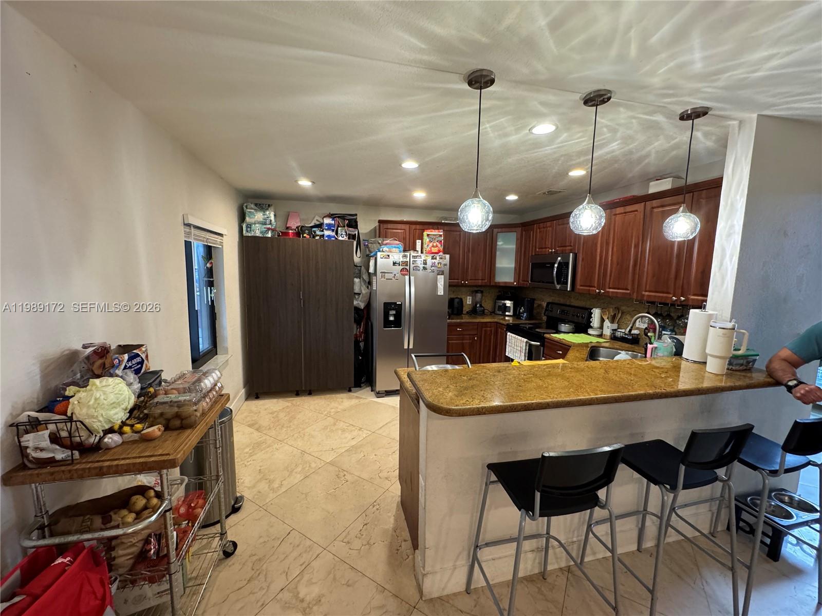 7632 Northwest 166th Terrace Hialeah, FL 33015 - Photo 5 of 20 a kitchen with a table and chairs in it