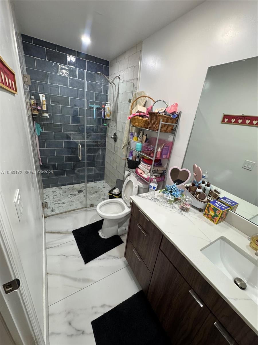 7632 Northwest 166th Terrace Hialeah, FL 33015 - Photo 6 of 20 a bathroom with a sink a toilet and shower