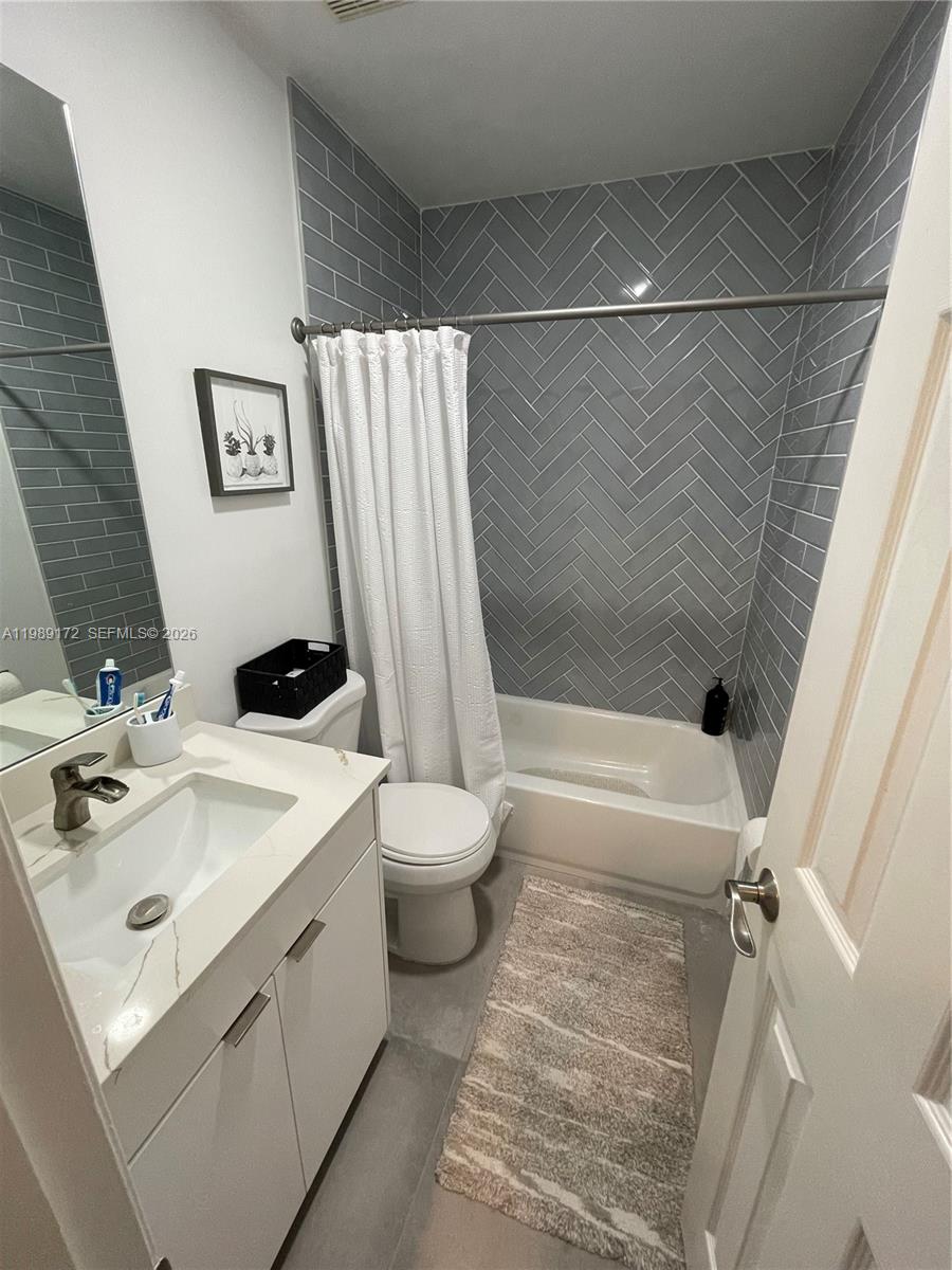 7632 Northwest 166th Terrace Hialeah, FL 33015 - Photo 10 of 20 a bathroom with a sink mirror vanity and toilet