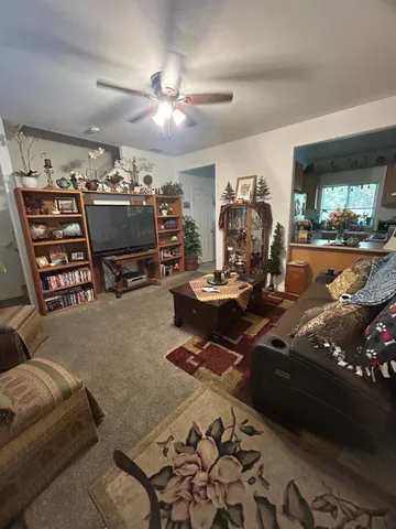 a view of a livingroom with furniture and a flat screen tv