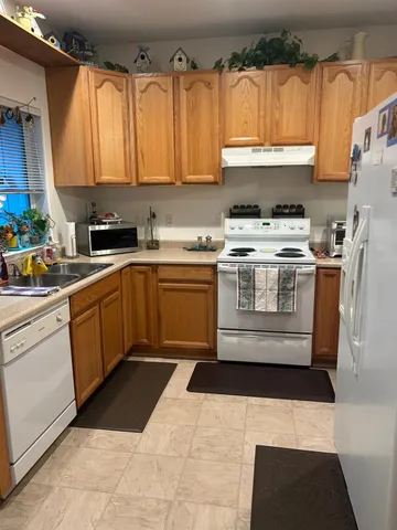 a kitchen with a stove a sink and a refrigerator