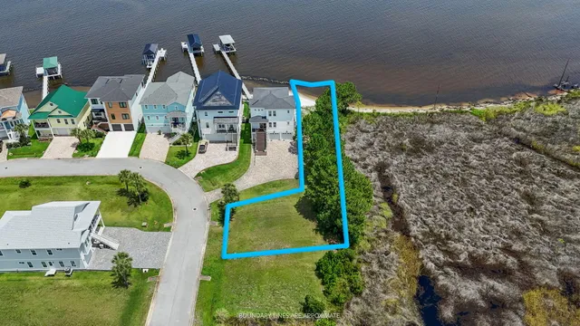 an aerial view of a house with a yard and lake view