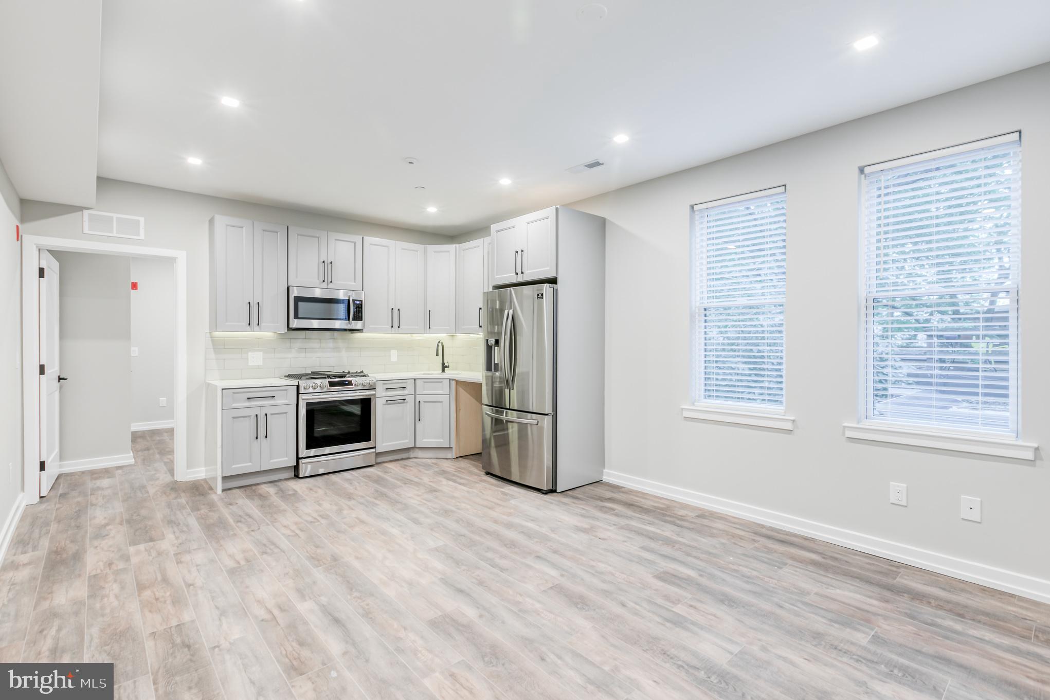 a kitchen with stainless steel appliances a refrigerator sink and cabinets