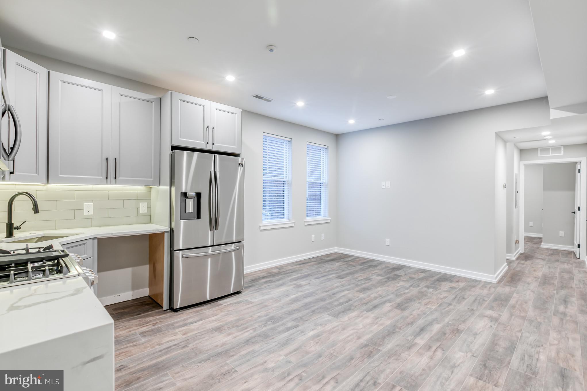 2026 Spring Garden Street, Unit 2B Philadelphia, PA 19130 - Photo 6 of 8 a kitchen with stainless steel appliances granite countertop a refrigerator and a stove top oven