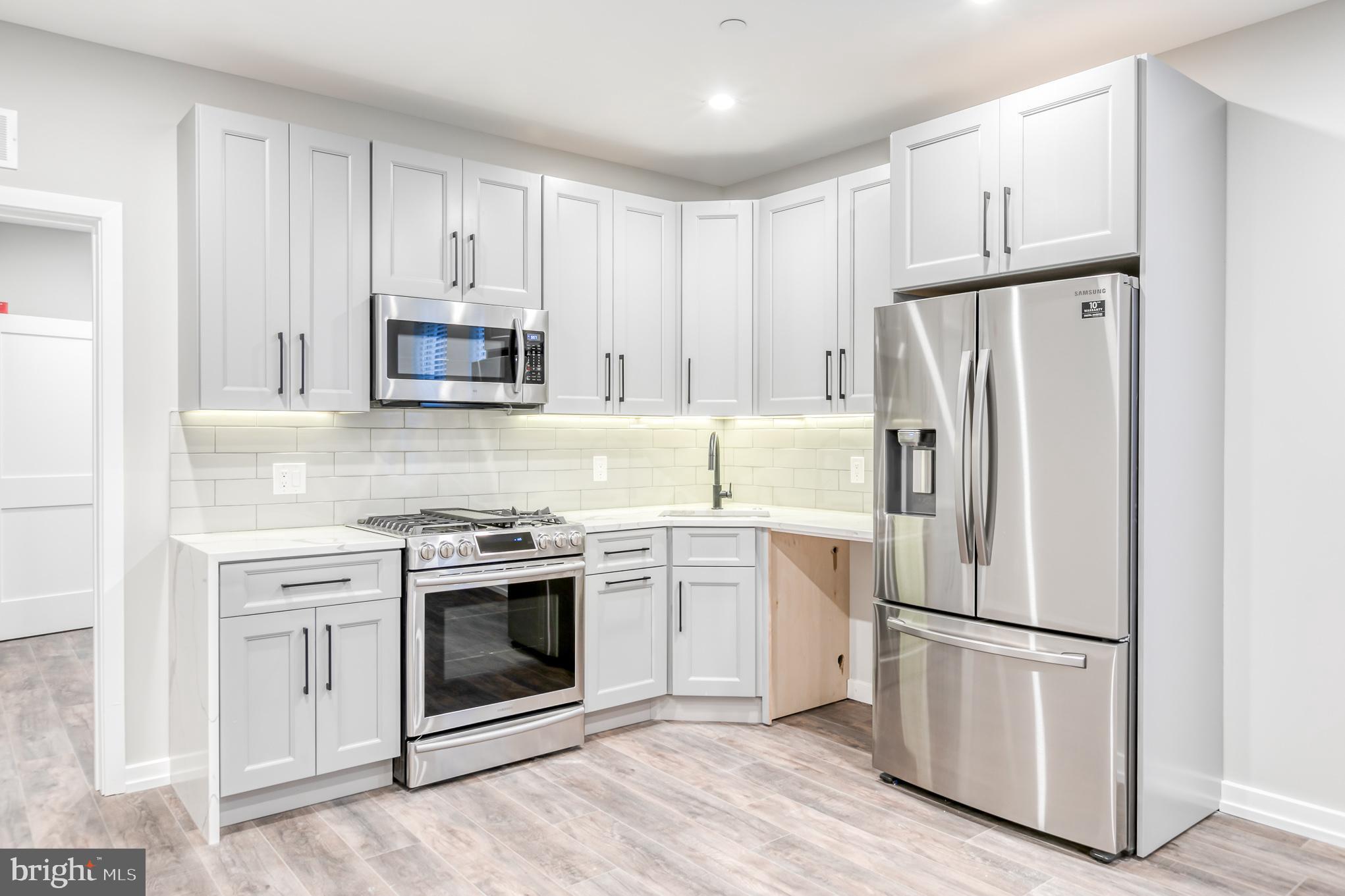 2026 Spring Garden Street, Unit 2B Philadelphia, PA 19130 - Photo 8 of 8 a white refrigerator freezer and a stove top oven