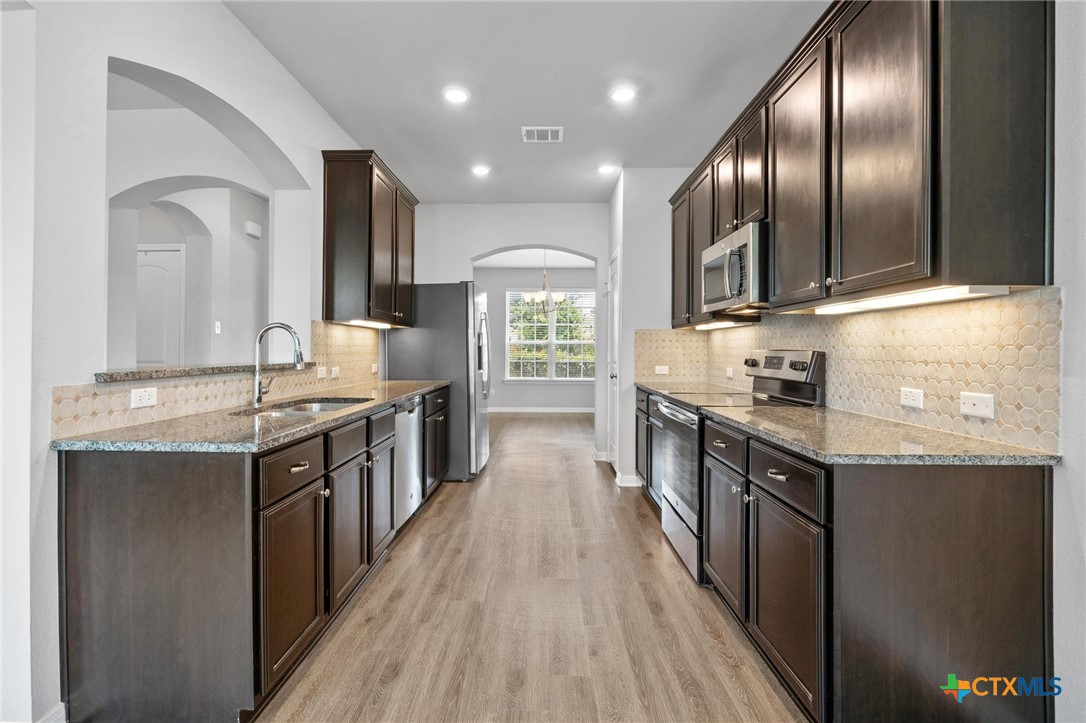 5338 Fenton Lane Belton, TX 76513 - Photo 13 of 33 a large kitchen with stainless steel appliances granite countertop a stove and a sink