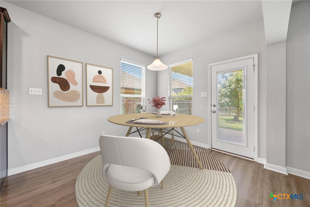 5338 Fenton Lane Belton, TX 76513 - Photo 14 of 33 a dining room with furniture a rug and wooden floor