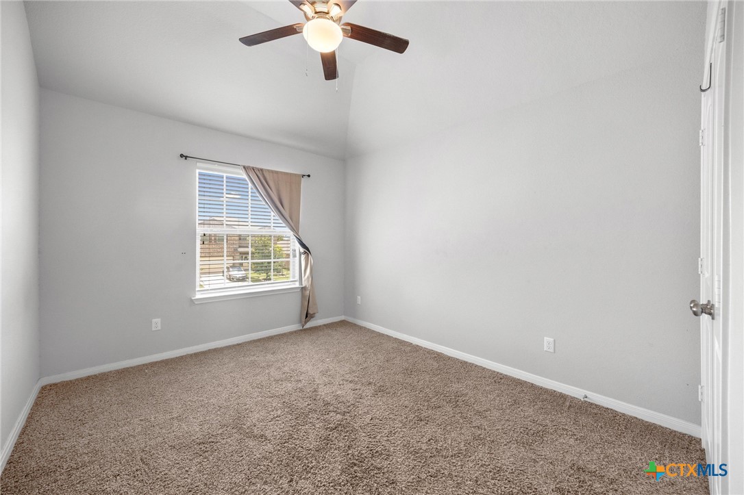 5338 Fenton Lane Belton, TX 76513 - Photo 25 of 33 an empty room with a chandelier fan and windows