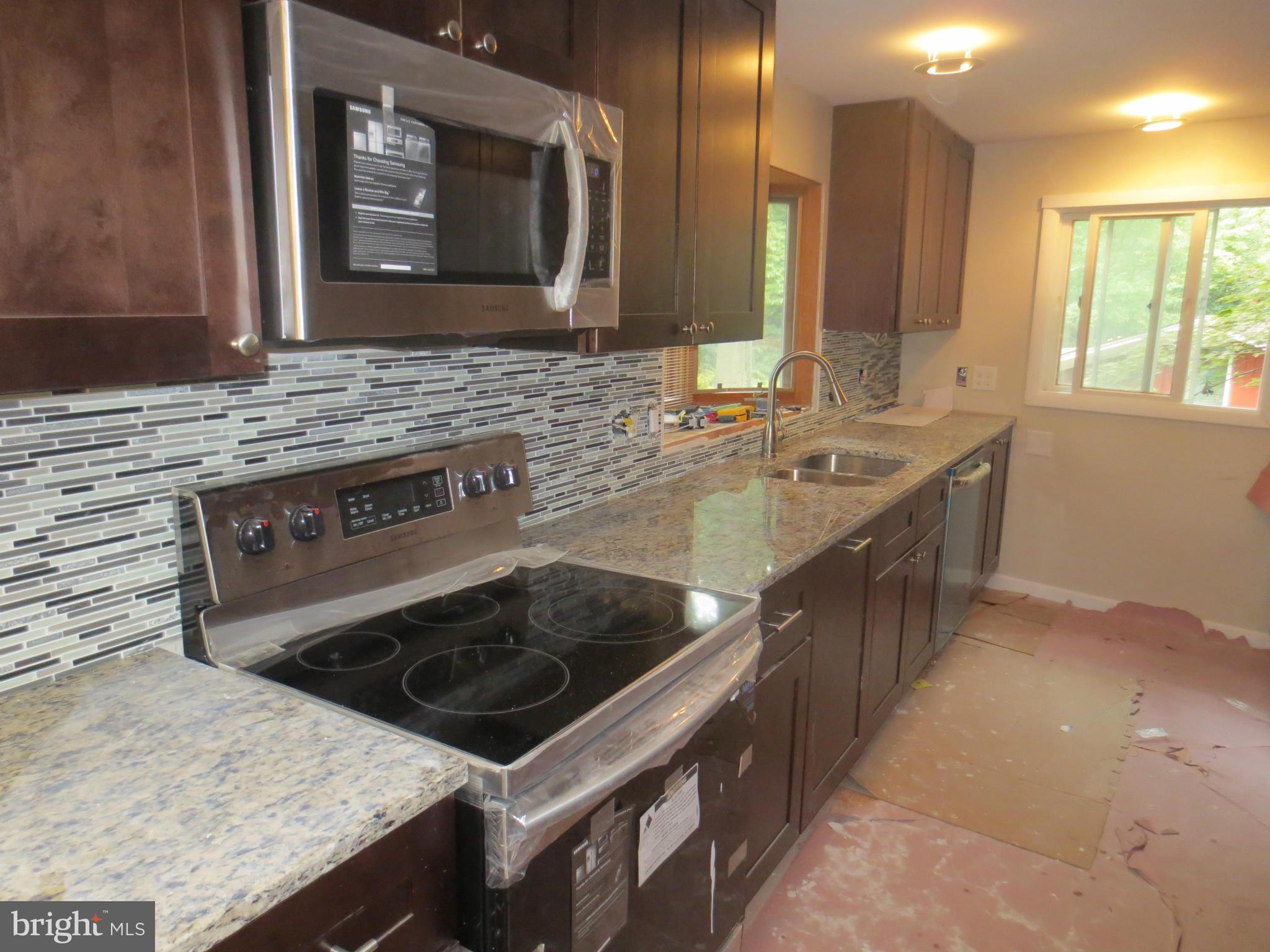 11532 Highview Avenue Silver Spring, MD 20902 - Photo 3 of 7 a kitchen with a stove sink and microwave