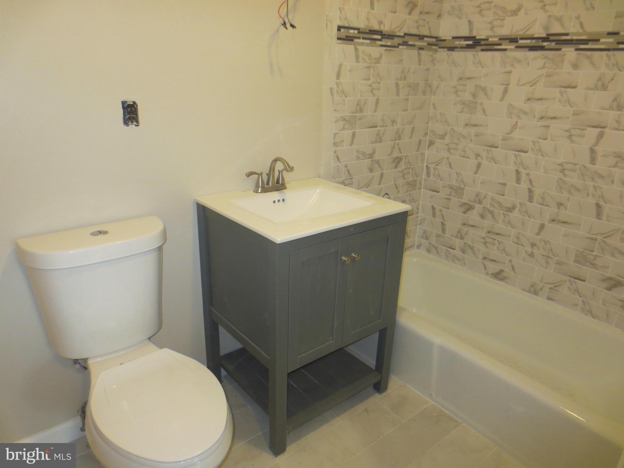 11532 Highview Avenue Silver Spring, MD 20902 - Photo 5 of 7 a white toilet sitting next to a bath tub