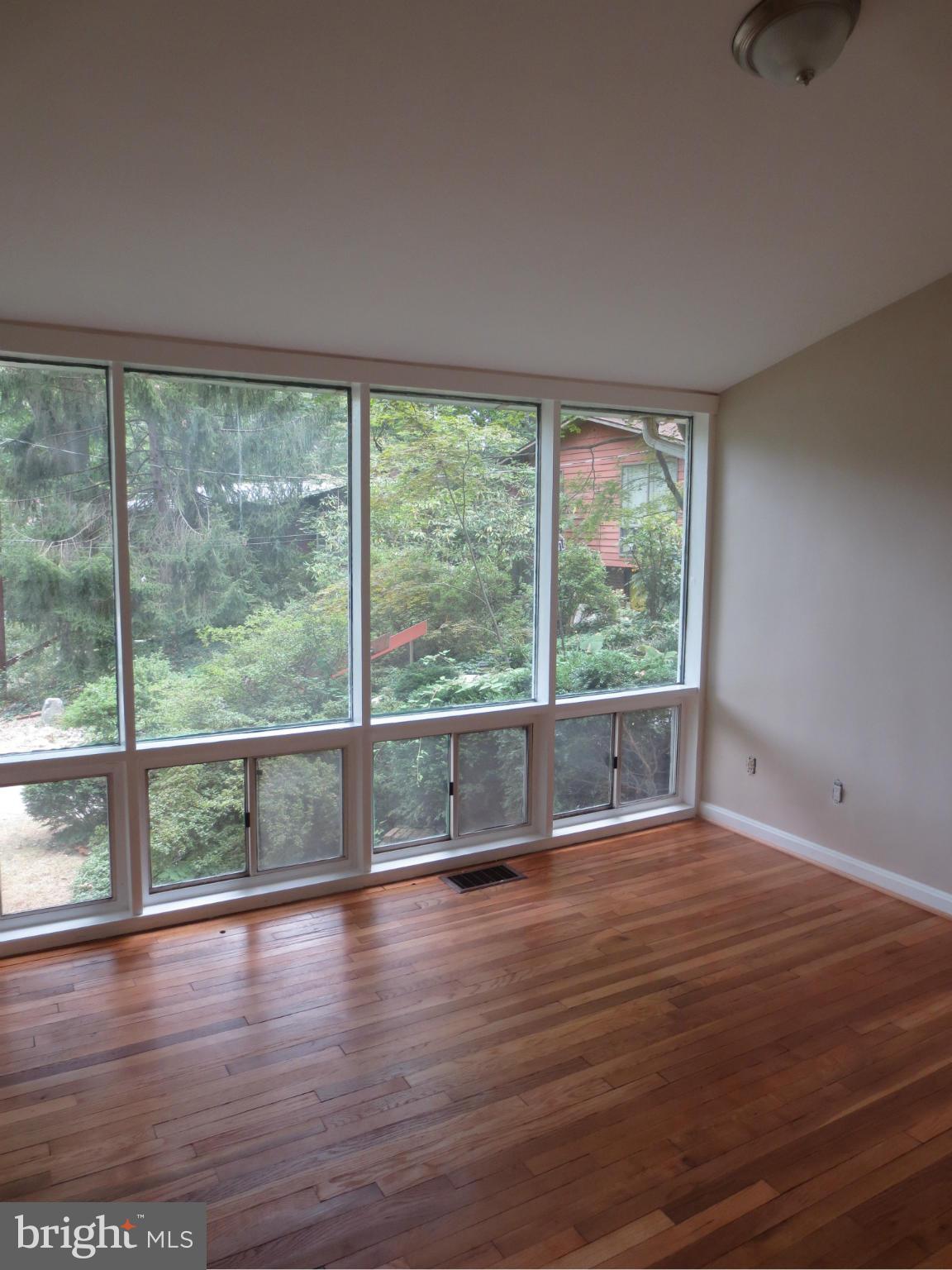 11532 Highview Avenue Silver Spring, MD 20902 - Photo 6 of 7 a view of empty room with wooden floor and fan