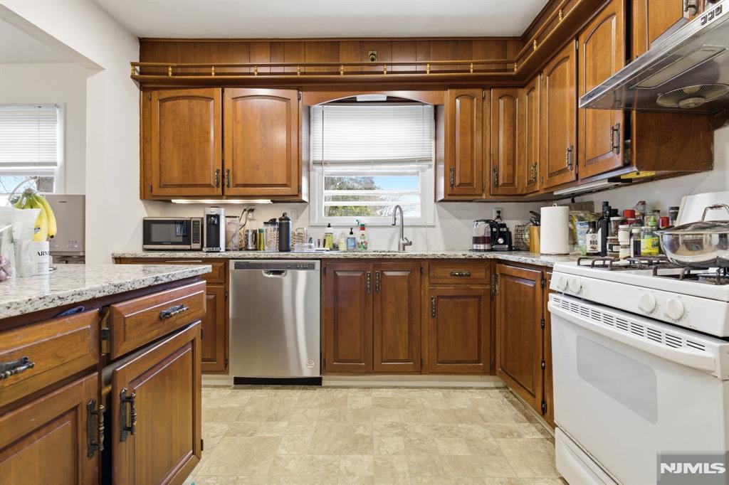 90 Cortlandt Place, Unit 2 Tenafly, NJ 07670 - Photo 3 of 3 a kitchen with stainless steel appliances granite countertop a sink a stove and a refrigerator