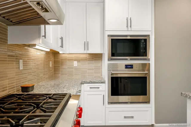 a stove top oven sitting inside of a kitchen