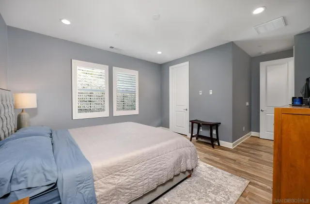 a spacious bedroom with a bed and a table in it