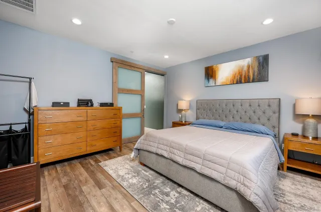 a bedroom with a bed and a dresser