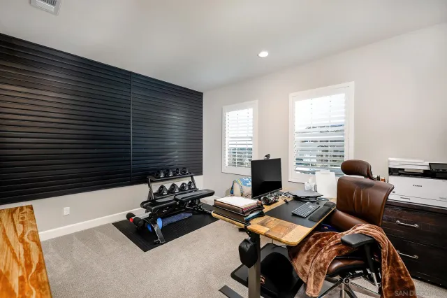 a bedroom with furniture and a large window