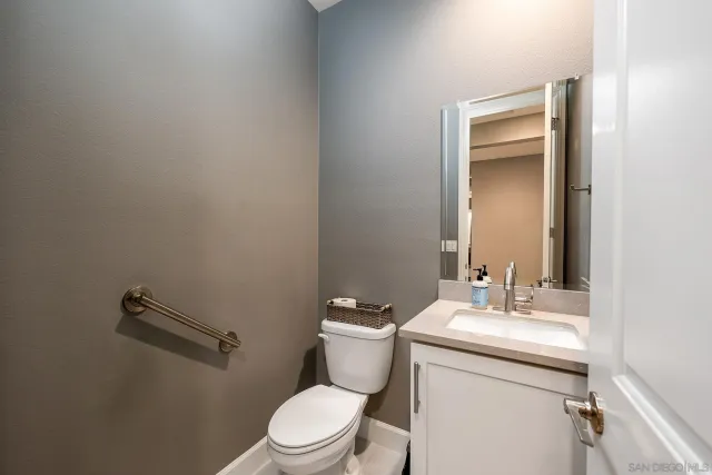a bathroom with a toilet a sink and mirror