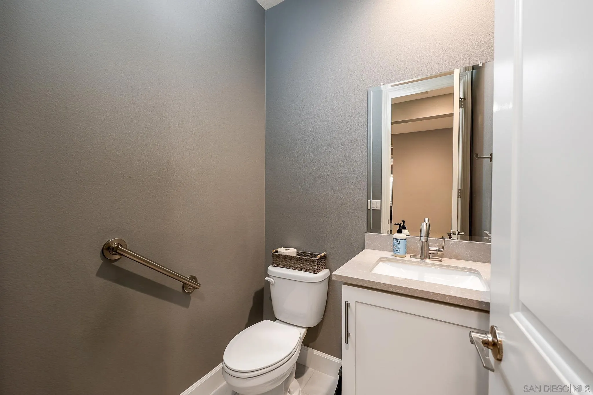 893 Woodhaven Road San Marcos, CA 92069 - Photo 21 of 33 a bathroom with a toilet a sink and mirror