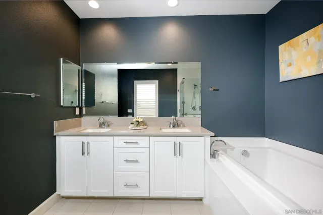 a view of bathroom with a tub sink and mirror