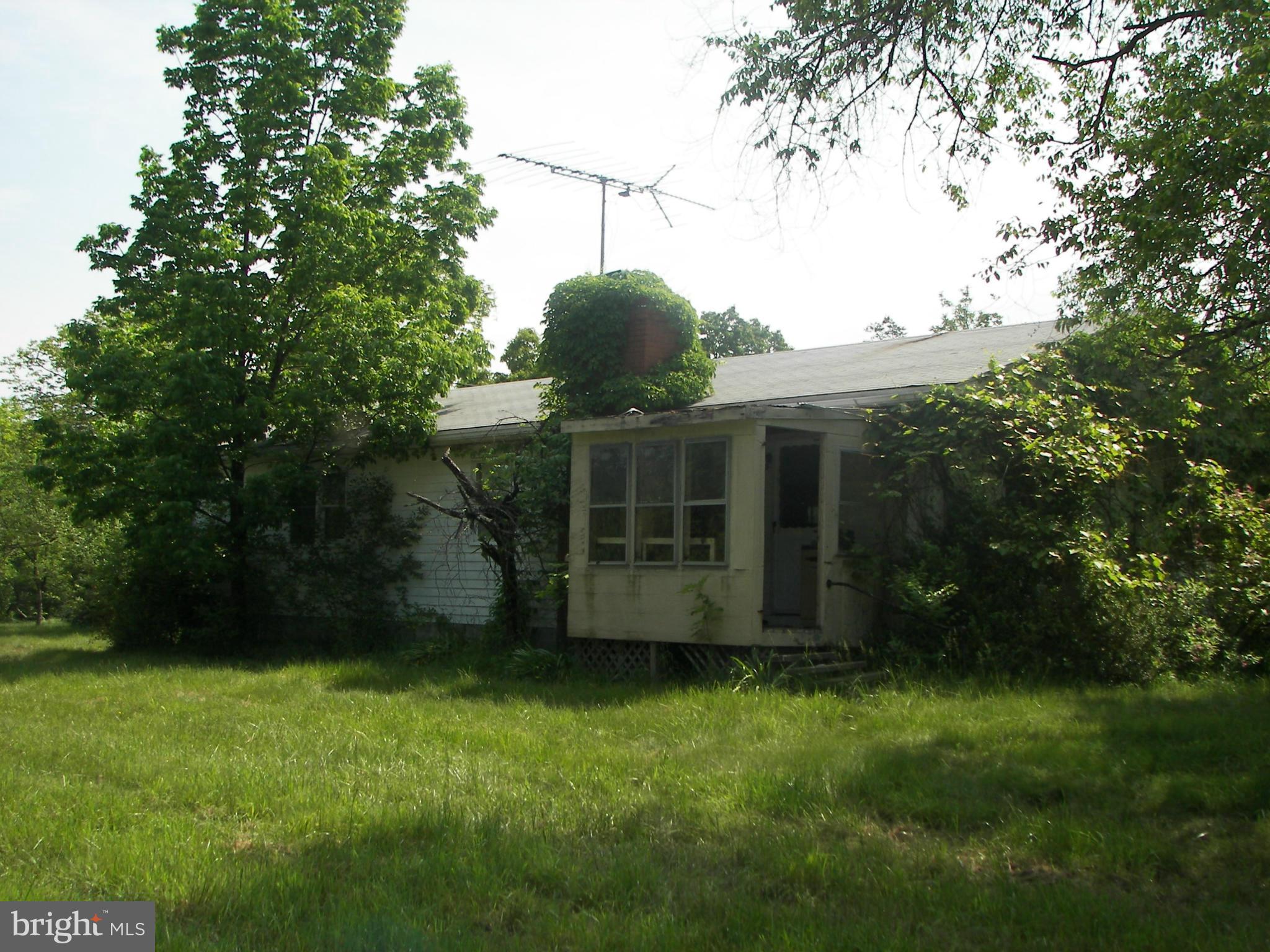 4355 Timber Ridge Road Berkeley Springs, WV 25411 - Photo 5 of 8 a view of a house with a backyard