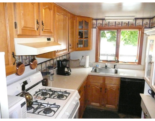 36 West Shore Road Holbrook, MA 02343 - Photo 5 of 9 a kitchen with a sink a stove and a refrigerator