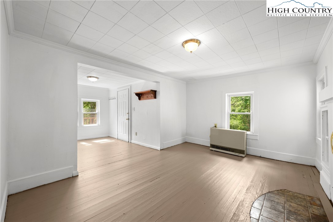 253 Old Blowing Rock Road Boone, NC 28607 - Photo 12 of 33 an empty room with wooden floor and windows