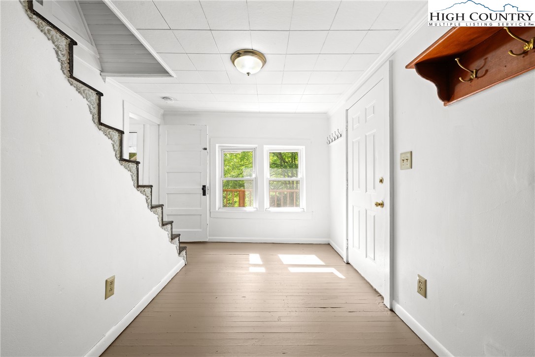 253 Old Blowing Rock Road Boone, NC 28607 - Photo 8 of 33 a view of a hallway with windows and stairs