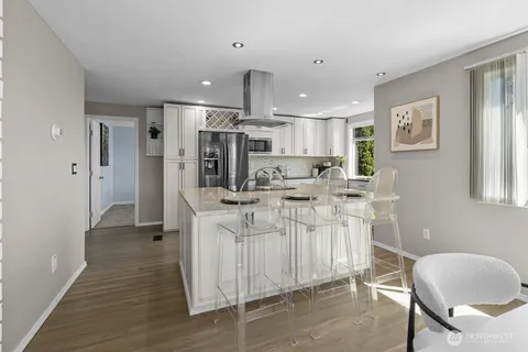 a kitchen with white cabinets and stainless steel appliances
