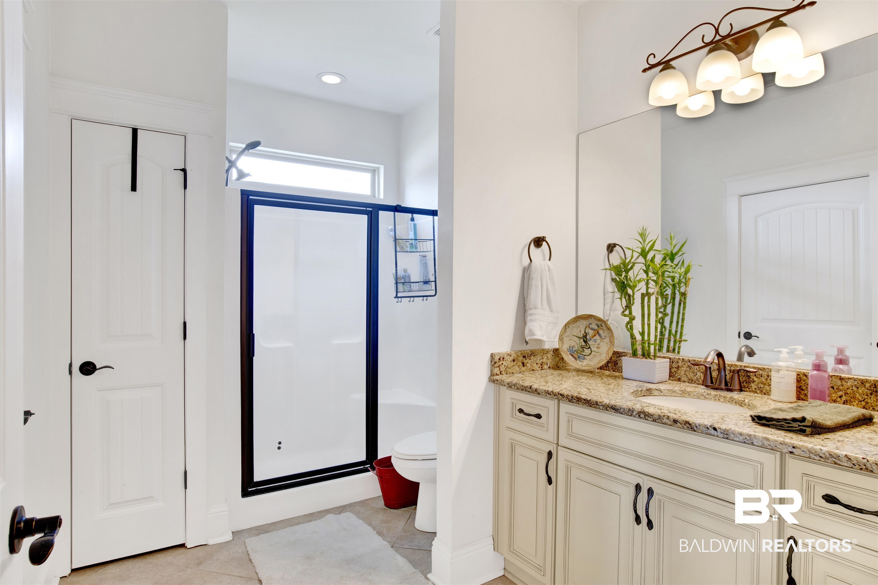 9240 Bay Point Drive Elberta, AL 36530 - Photo 17 of 22 Bathroom featuring tile patterned floors, toilet, an enclosed shower, and vanity