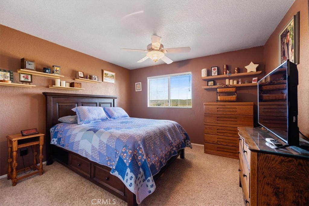 2100 Starkey Road Shandon, CA 93461 - Photo 12 of 39 a bedroom with a bed and a chandelier