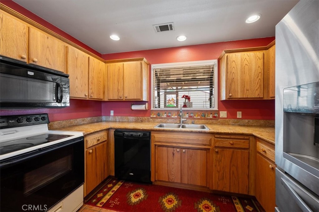 2100 Starkey Road Shandon, CA 93461 - Photo 10 of 39 a kitchen with stainless steel appliances a sink stove and cabinets