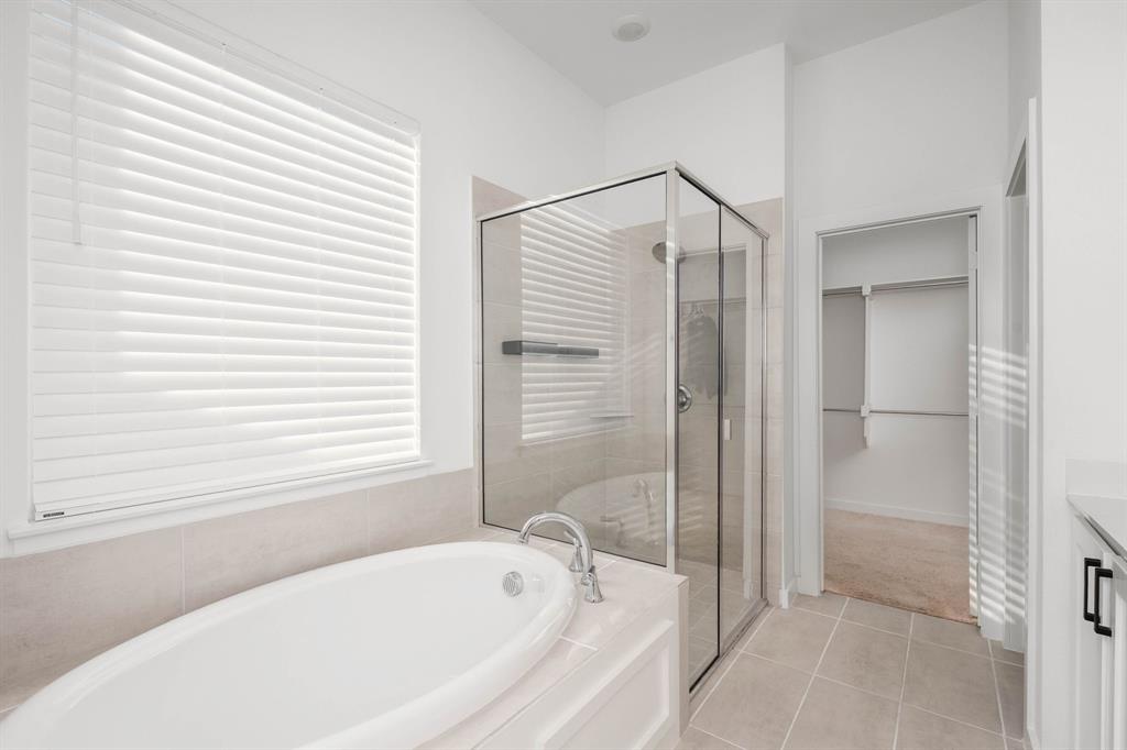 817 Isabel Street Celina, TX 75009 - Photo 14 of 39 a bathroom with a bathtub and a shower
