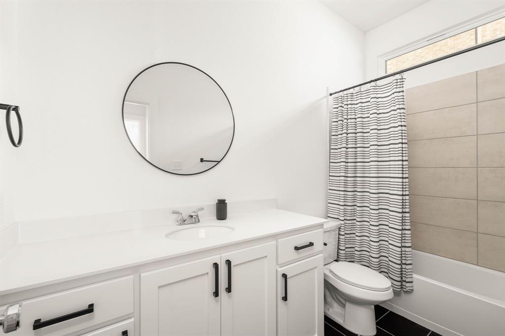 817 Isabel Street Celina, TX 75009 - Photo 16 of 39 a bathroom with a sink toilet and a mirror
