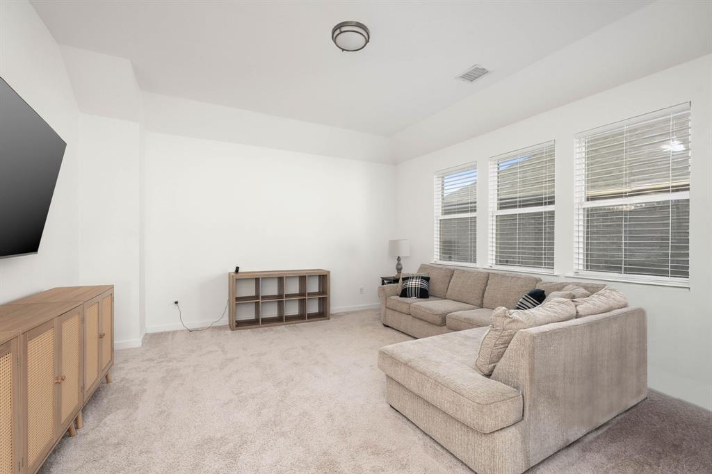 817 Isabel Street Celina, TX 75009 - Photo 20 of 39 a living room with furniture and a flat screen tv