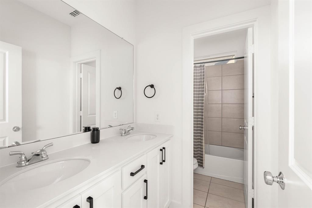 817 Isabel Street Celina, TX 75009 - Photo 24 of 39 a bathroom with a double vanity sink mirror and shower