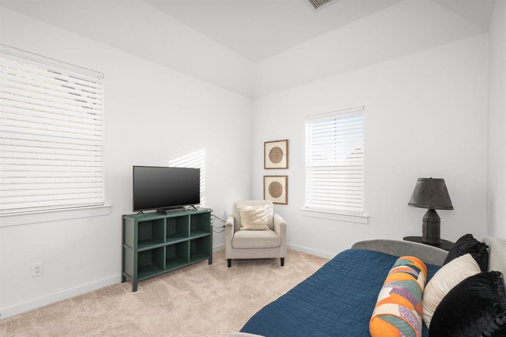 817 Isabel Street Celina, TX 75009 - Photo 26 of 39 a bed room with a bed television and a window