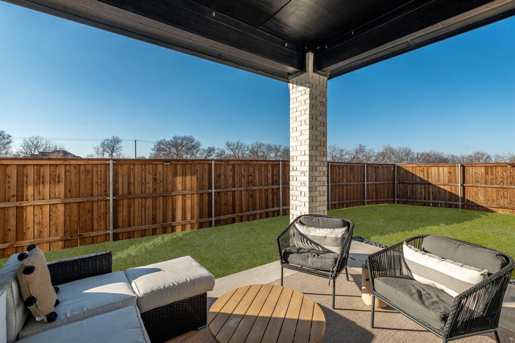 817 Isabel Street Celina, TX 75009 - Photo 29 of 39 a view of a chairs and table in the back yard of the house