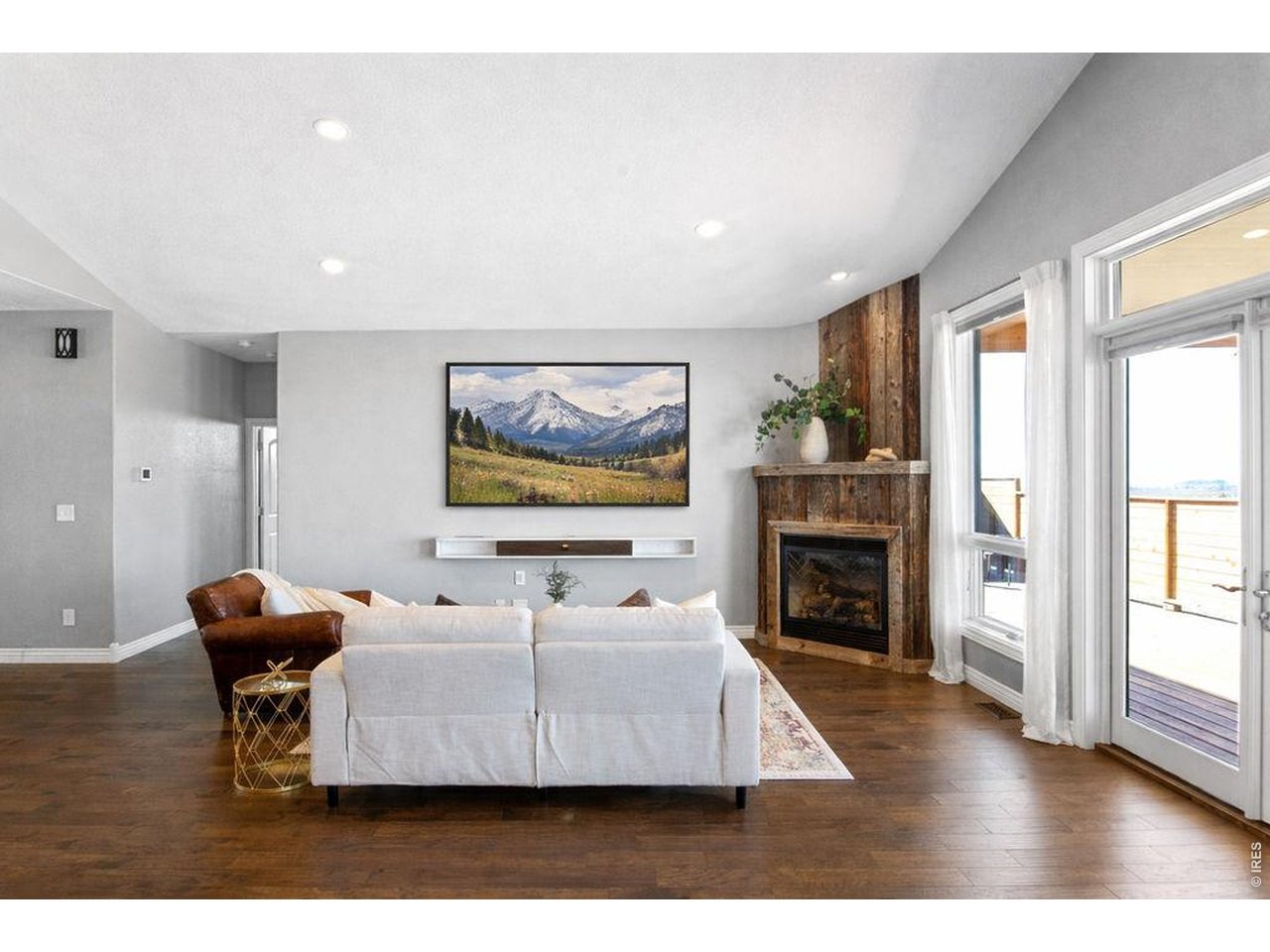 3050 Native Court Wellington, CO 80549 - Photo 5 of 50 Bright and inviting living space with abundant natural light and a cozy fireplace focal point