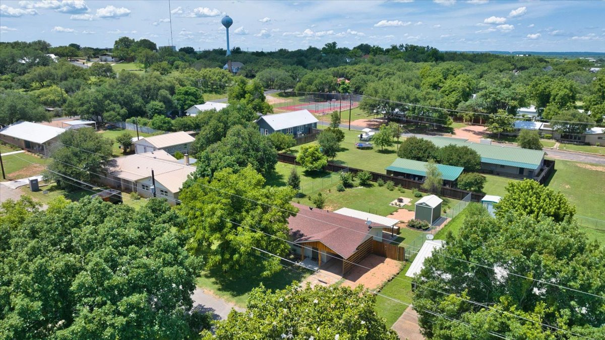 1236 Martin Street Mason, TX 76856 - Photo 38 of 40 An aerial panorama reveals a neighborhood dotted with mature trees, offering an ideal setting for tranquil living.