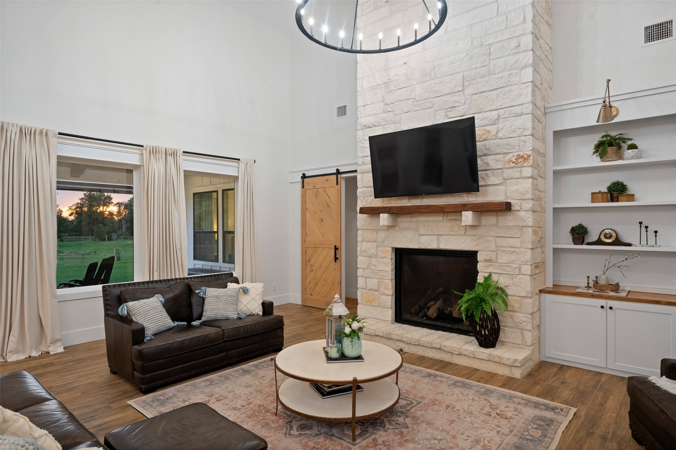 27201 Double Culvert Road Hempstead, TX 77445 - Photo 12 of 49 Close-up of the living room fireplace reveals stone surround, rustic mantel, and built-in shelving for display or storage.