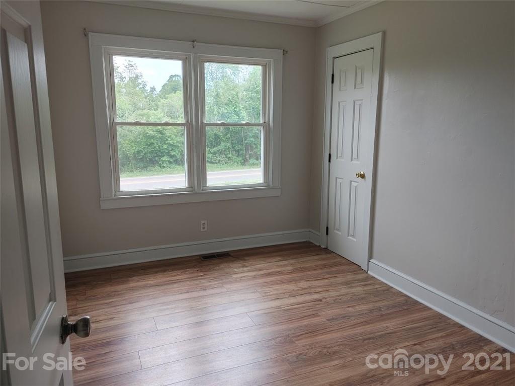 7312 Cheatham Ford Road Hiddenite, NC 28636 - Photo 11 of 16 an empty room with wooden floor and windows