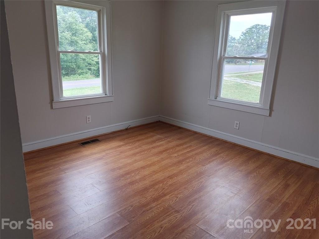 7312 Cheatham Ford Road Hiddenite, NC 28636 - Photo 12 of 16 an empty room with wooden floor and windows