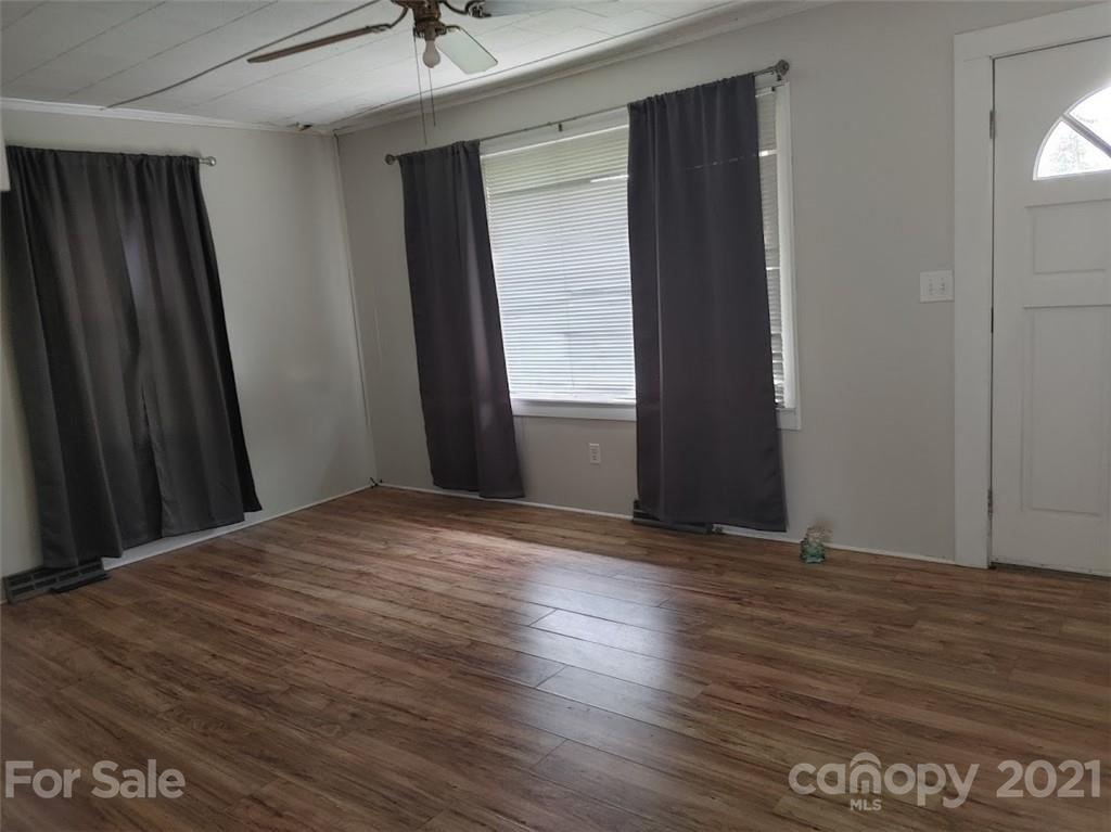 7312 Cheatham Ford Road Hiddenite, NC 28636 - Photo 15 of 16 a view of an empty room with wooden floor and a window
