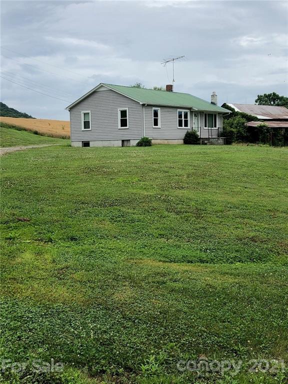 7312 Cheatham Ford Road Hiddenite, NC 28636 - Photo 3 of 16 a view of house with a big yard