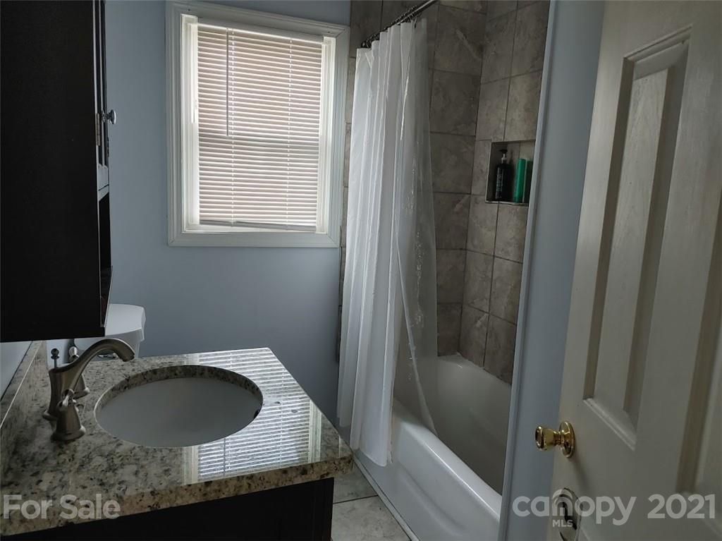 7312 Cheatham Ford Road Hiddenite, NC 28636 - Photo 9 of 16 a bathroom with a sink and a mirror