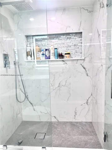 a view of a bathroom with a sink and a shower