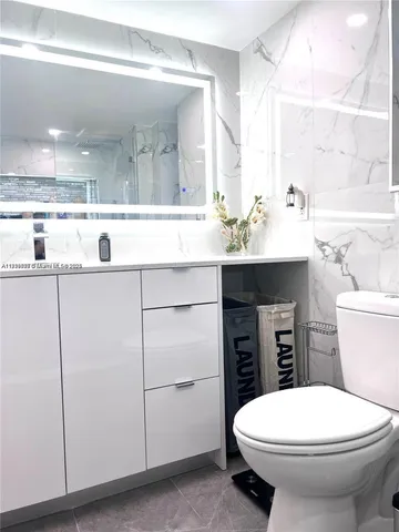 a bathroom with a sink a toilet and mirror