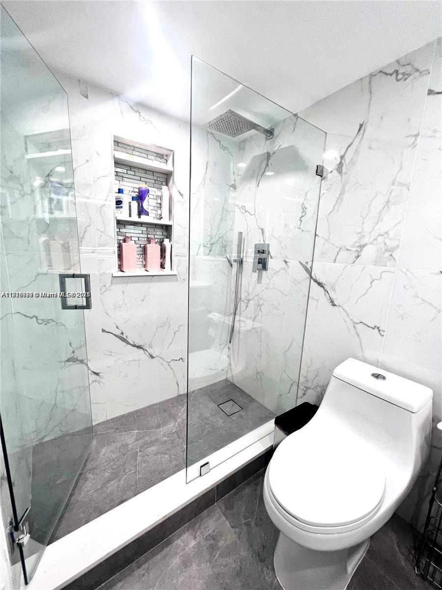 20200 West Country Club Drive, Unit 112 Aventura, FL 33180 - Photo 8 of 20 a bathroom with a toilet and a shower