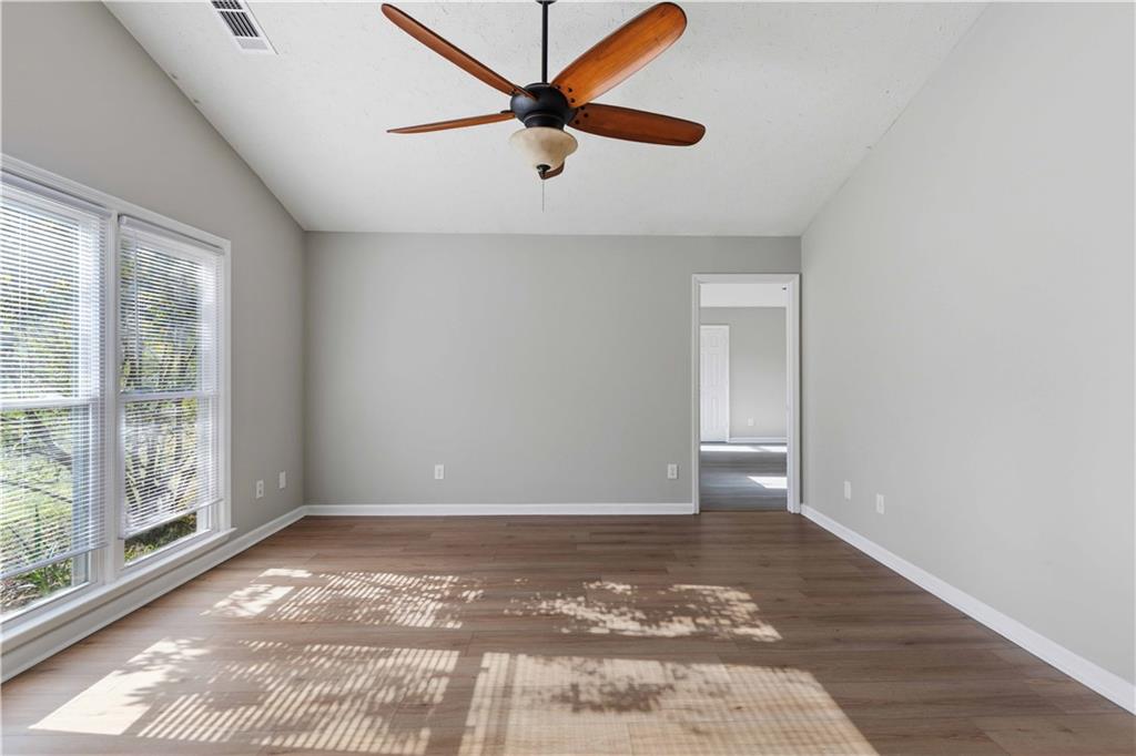 4 Ford Road Phenix City, AL 36869 - Photo 6 of 52 Vaulted ceiling, wood-finish flooring, ceiling fan with light fixture, double windows with blinds, and neutral wall paint