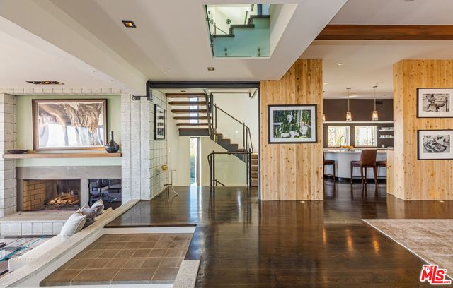 a living room with furniture a fireplace and wooden floor